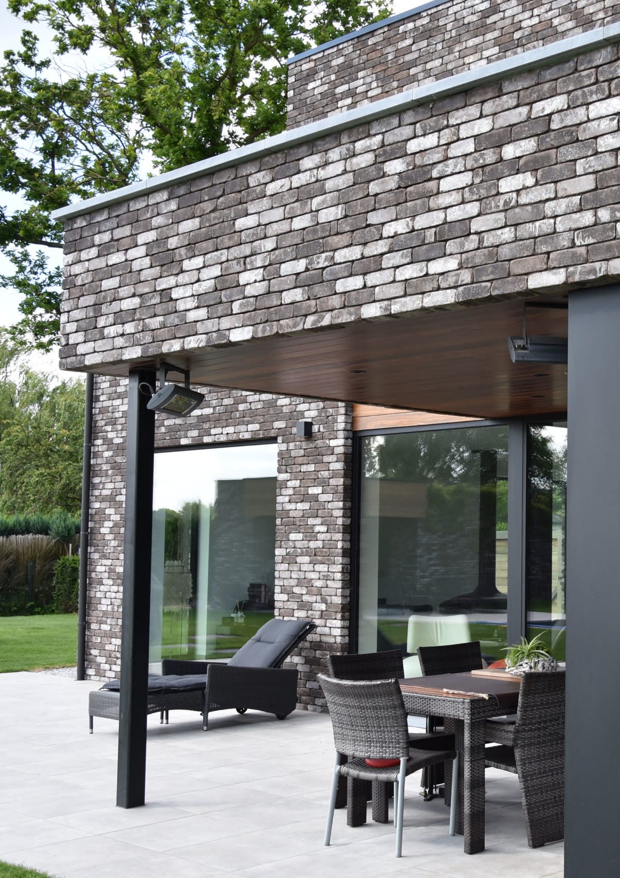 Dark Grey Range of brick of a backyard with patio furniture