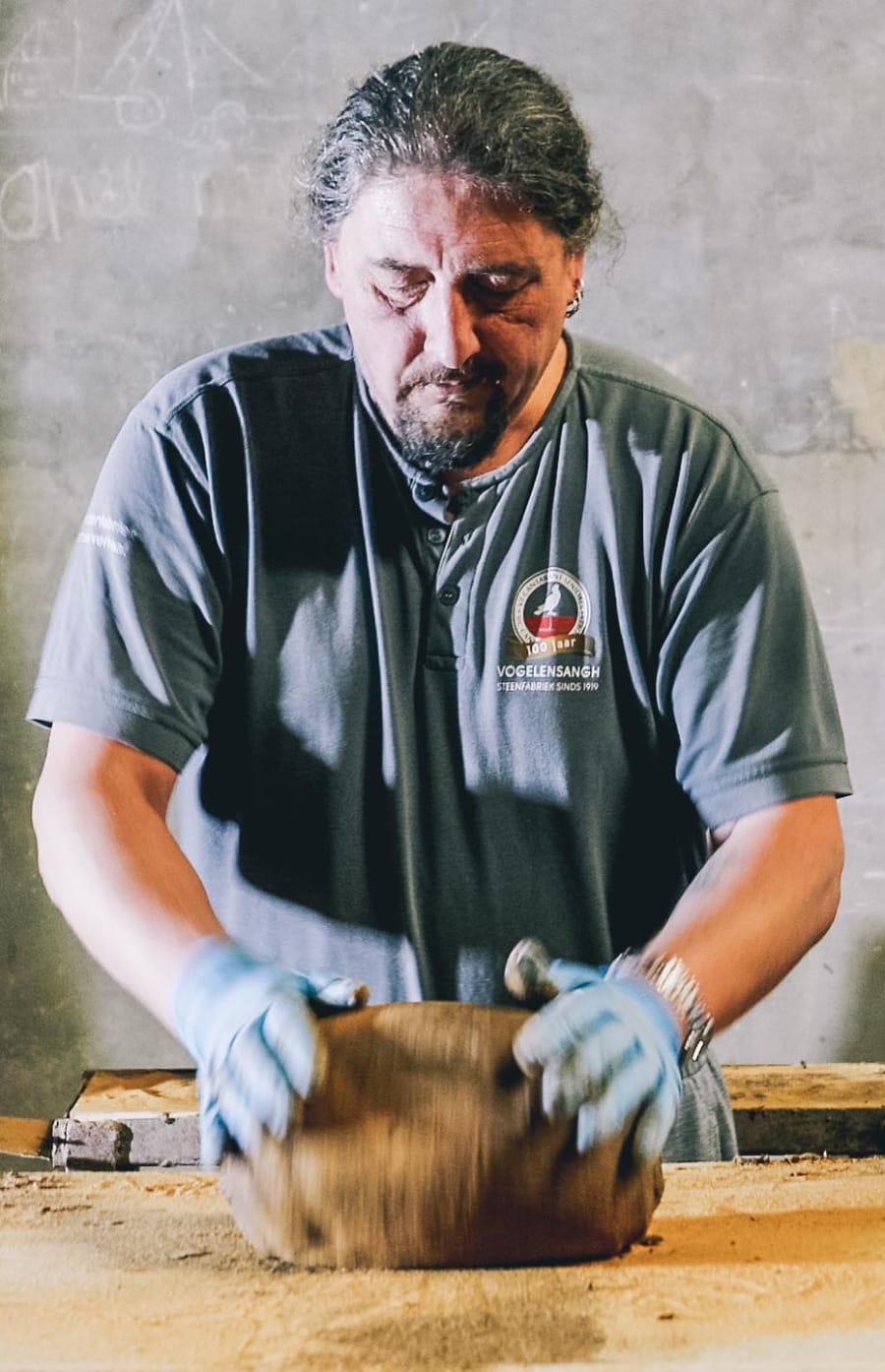 Man molding clay into bricks.