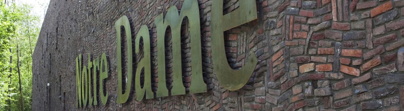 Brick wall with Notre Dame sign.