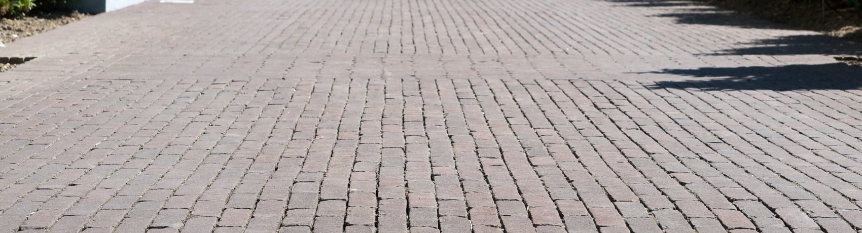 Pavers from kreitmaker make up a driveway.